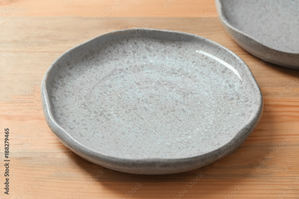 Ceramic plate on wooden background