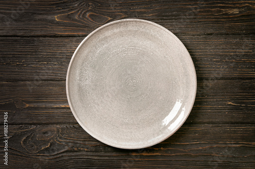 Fototapeta Ceramic plate on wooden background