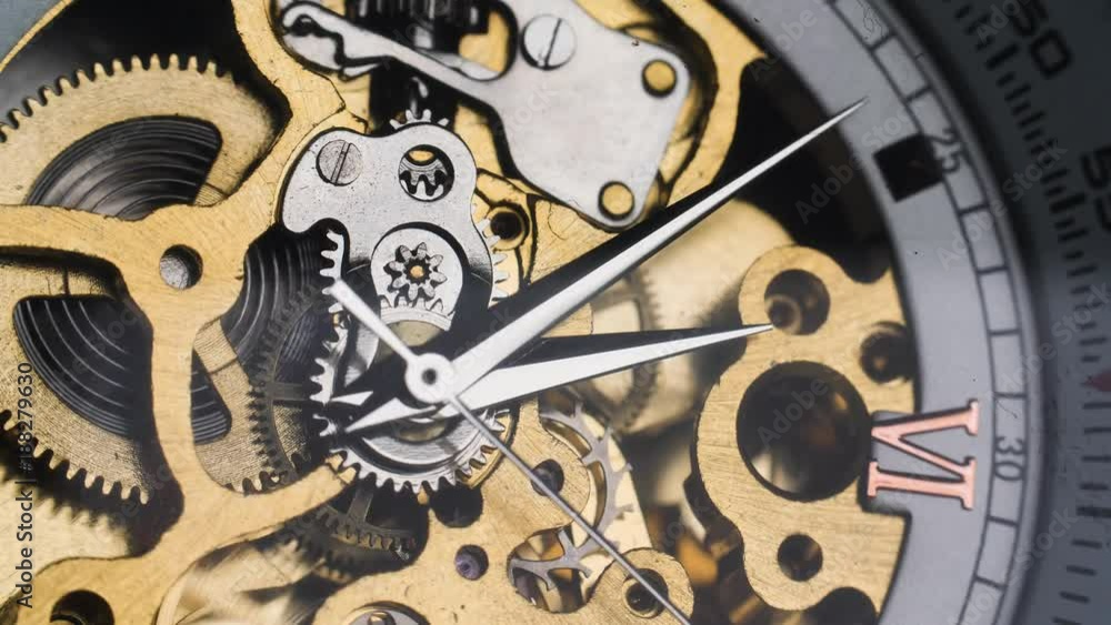 Mechanical golden retro skeleton watch with visible spinning gears and ticking as the hands move around Mechanical golden retro skeleton watch with visible spinning gears and ticking as the hands move around