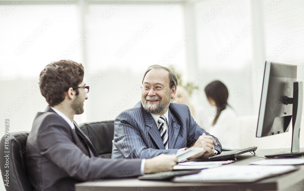 members of a business team discussing business documents in the workplace in the office members of a business team discussing business documents in the workplace in the office