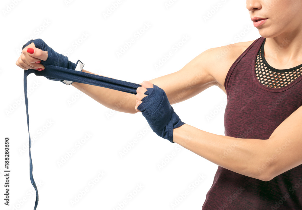 Boxer woman applying wrist wraps on white background Boxer woman applying wrist wraps on white background