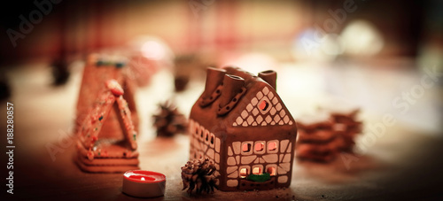 gingerbread house in the background of the Christmas table