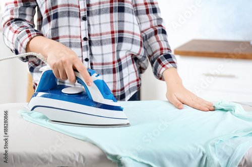 Woman ironing laundry, indoors