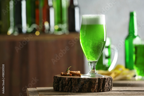 Glass of green beer on table in bar. Saint Patrick's day celebration