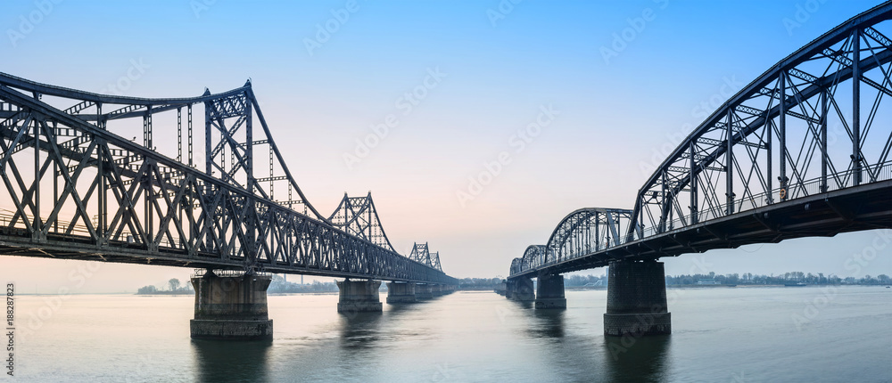 Yalu River Bridge. In the distance is North Korea. Located in Dandong, Liaoning, China. Yalu River Bridge. In the distance is North Korea. Located in Dandong, Liaoning, China.
