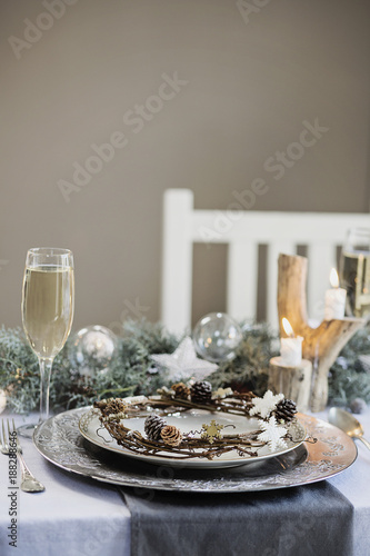 Holiday celebration table setting. White, gold and silver christmas table setting photo