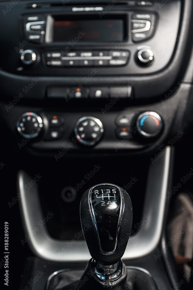 close up of gear shift in the car and central console in the background
