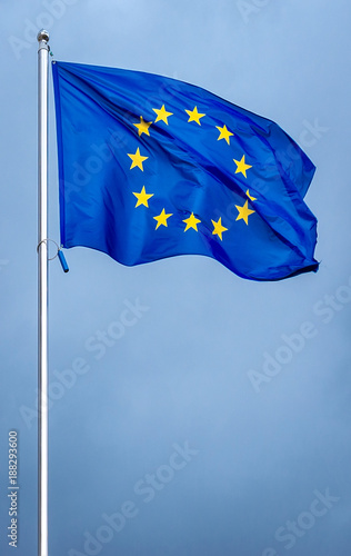 The flag of the European Union , against the background of the sunny sky.