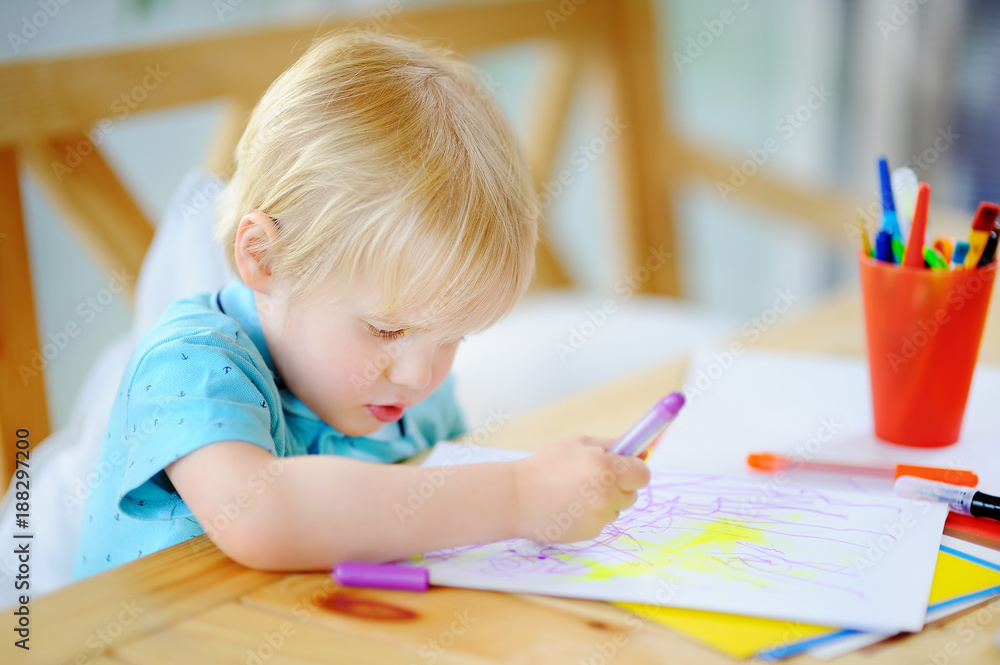 Cute little boy drawing and painting with colorful markers pens at kindergarten Cute little boy drawing and painting with colorful markers pens at kindergarten