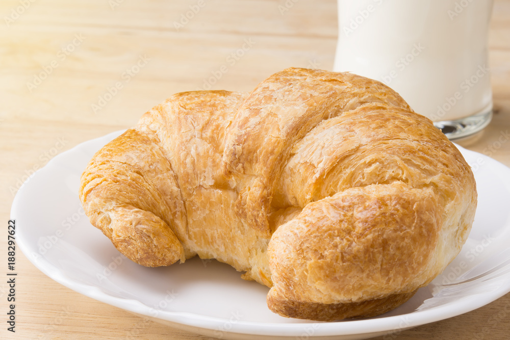 croissant on white plate on wooden table