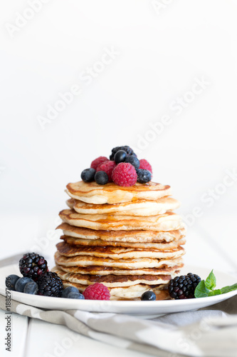 Pancakes with berries and honey. Copy space
