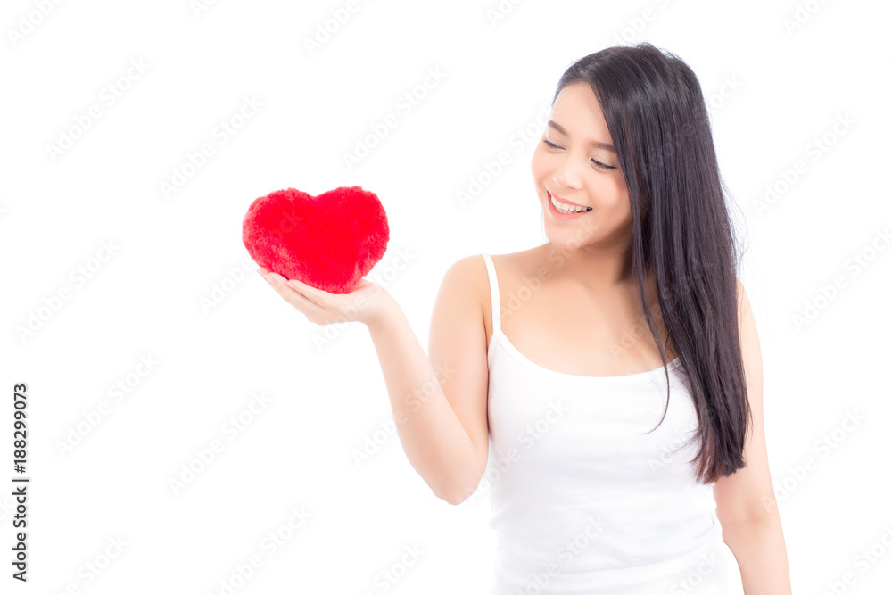 Portrait of beautiful asian young woman holding red heart shape pillow and smile isolated on white background, valentines day, holiday concept. Portrait of beautiful asian young woman holding red heart shape pillow and smile isolated on white background, valentines day, holiday concept.