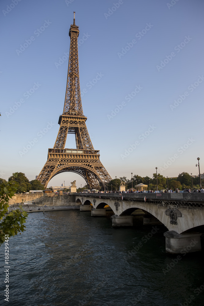 Eiffel Tower at sunset in Paris, France. Romantic travel background.