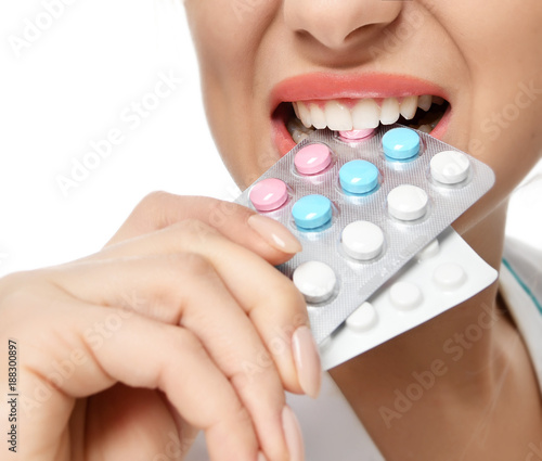 Female doctor offering pack of pills capsules blue to the patient in hand 