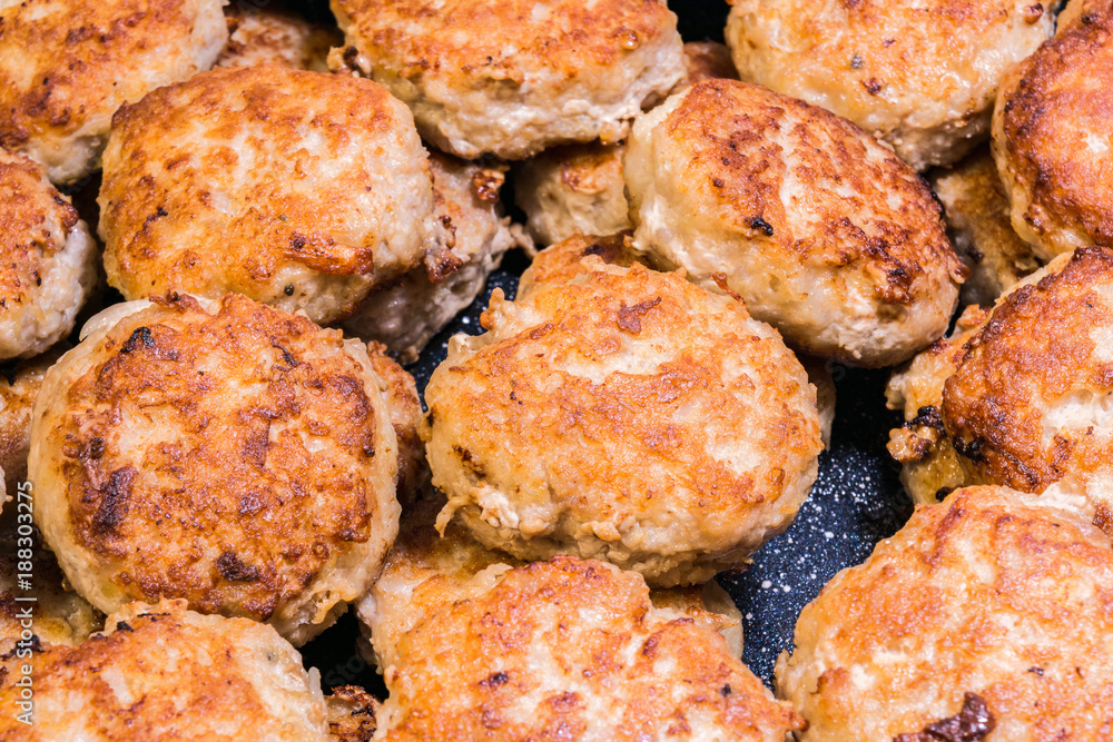 lots of fried chops in a frying pan, homemade Russian cuisine, food background lots of fried chops in a frying pan, homemade Russian cuisine, food background