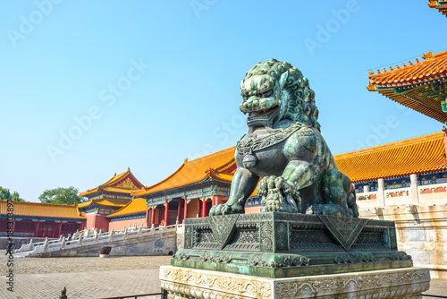 Chinese guardian lion. People are visiting. Located in The Palace Museum (Forbidden City), Beijing, China.	