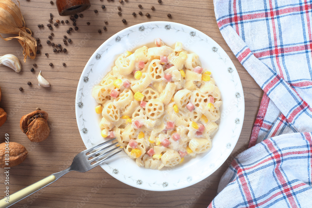 Italian wagon wheel shape pasta with ham and corn Italian wagon wheel shape pasta with ham and corn