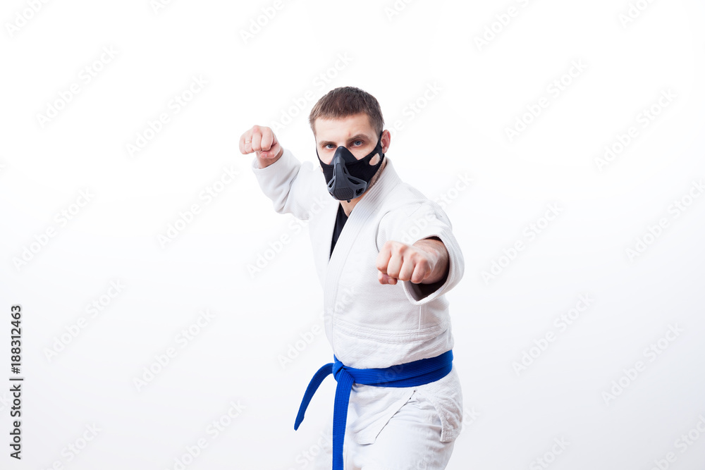 Young man fighter in a white kimono with blue belt for judo, jujitsu pose  on isolated white background Stock Photo | Adobe Stock