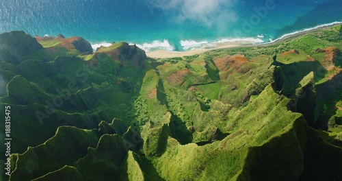 Cinematic aerial view of dramatic mountains and ocean on Napali Coast, Kauai, Hawaii photo