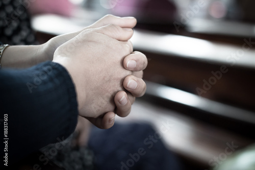 The hand of a woman holding hands praying prayer.