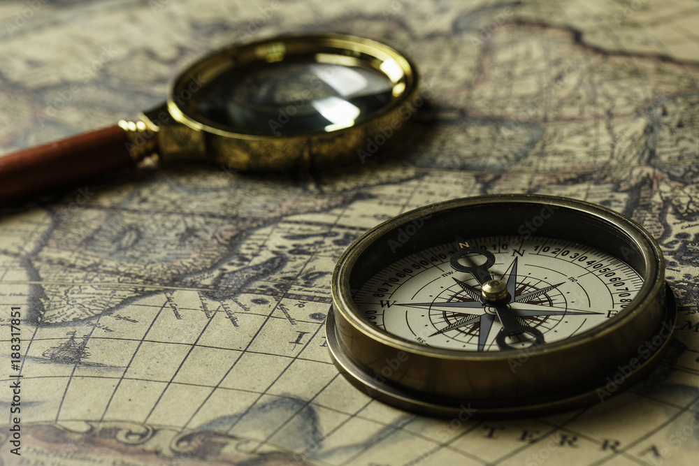 Retro compass with old map and magnifier Retro compass with old map and magnifier