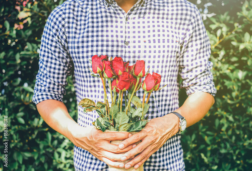 A man holding red roses in the garden.Soft Focus Image.