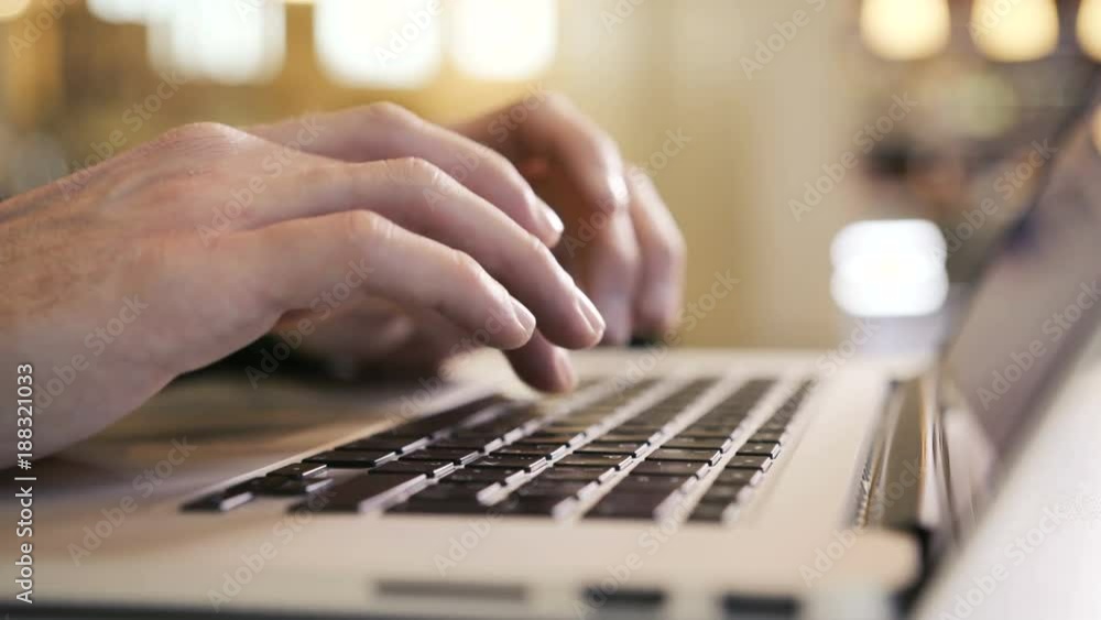 A businessman typing his fingers on the laptop keyboard writes an e-mail to team partners about the analysis of startup while waiting for his coffee. Working with modern technologies and information A businessman typing his fingers on the laptop keyboard writes an e-mail to team partners about the analysis of startup while waiting for his coffee. Working with modern technologies and information