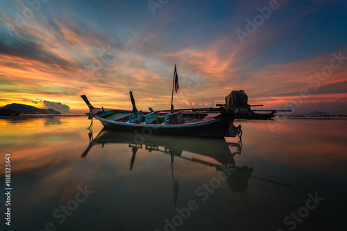 Long tail boat on beautiful sunrise at the sea in Phuket, Thailand.