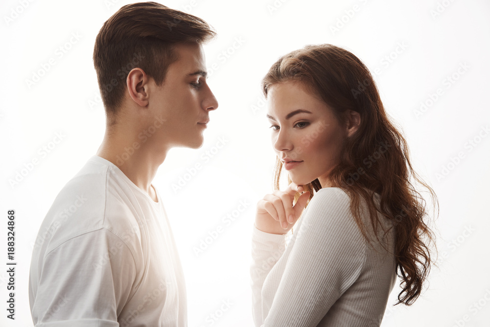 Picture of two young people in love standing close to each other. Their date came to an end. She waits when guy will make the first move but he awkwardly hesitates because he is shy Picture of two young people in love standing close to each other. Their date came to an end. She waits when guy will make the first move but he awkwardly hesitates because he is shy