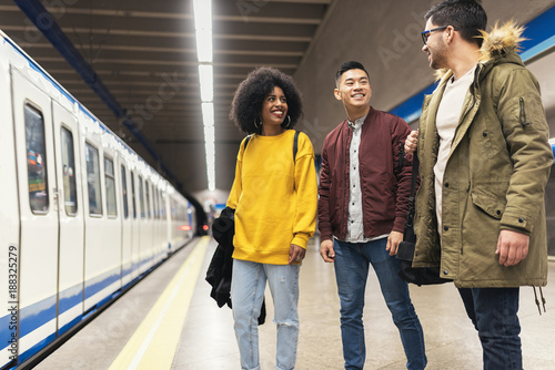 Group of friends waiting the train in the platform of subway station.