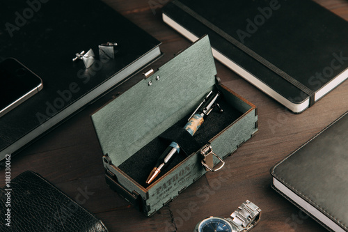 set of expensive military pens in wooden boxes, compositions on a dark background with attributes