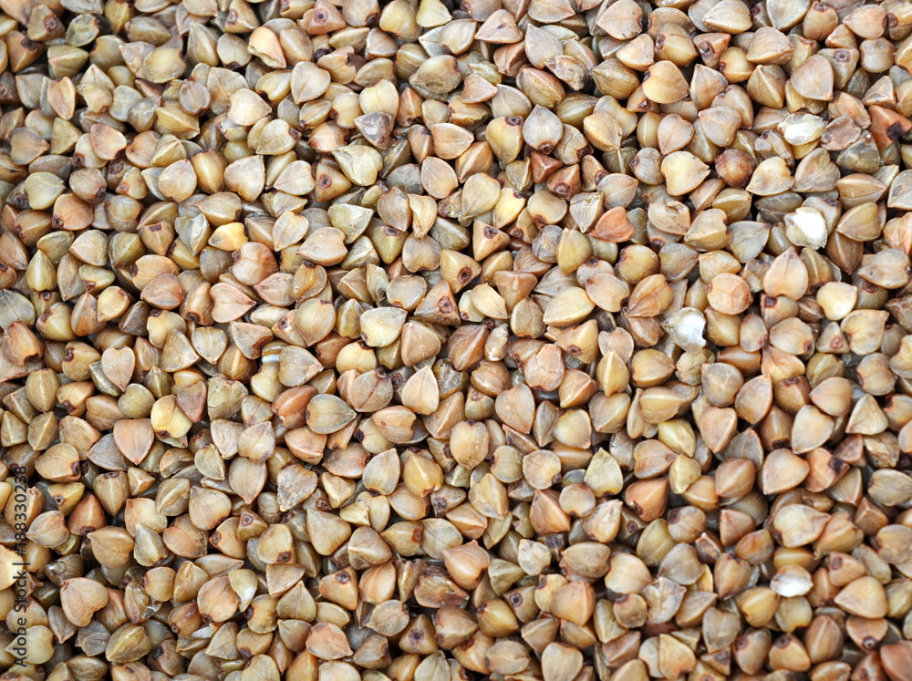 Raw brown buckwheat grain. Texture. Background Raw brown buckwheat grain. Texture. Background