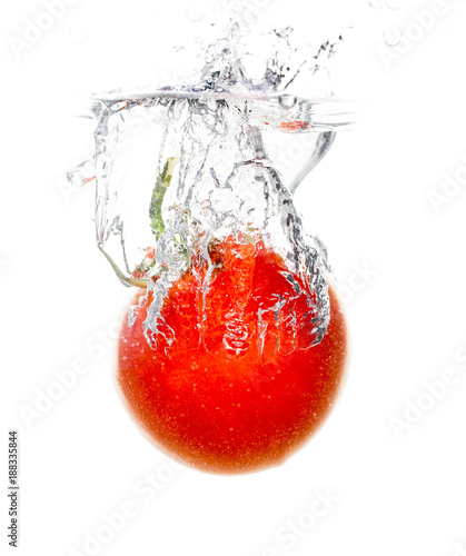 Red tomato under water on a white background