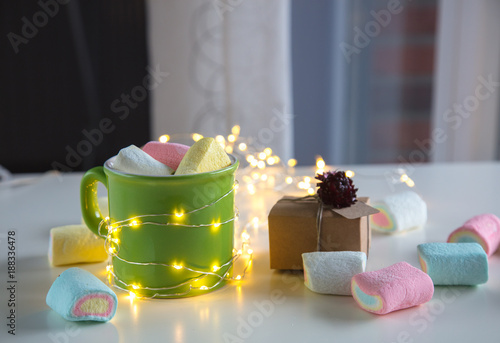 coffee cup with marshmallows and gift box