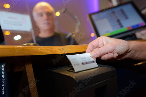 Ticket being printed from machine in booth