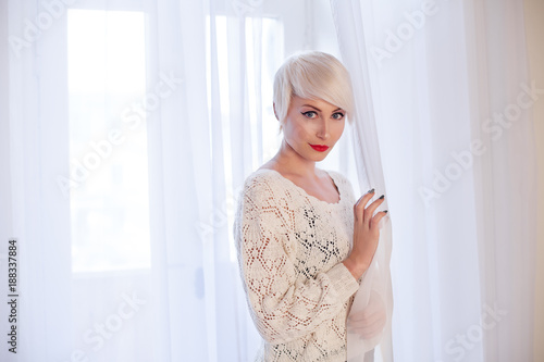 French blonde in a white room photo