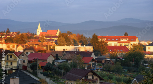 Church in village Senkvice with mountain background at dramatic sunset, Slovakia