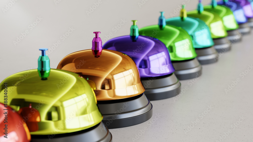 Fototapeta premium Line of Vibrantly Colored Reception Bells on Simple Light Grey Surface