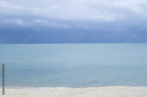 Turquoise sea water surface with horizon and blue sky