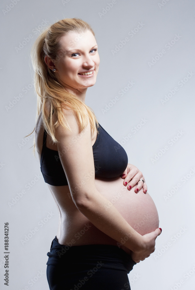 Pregnant Blond Woman in Black Bra. Pregnant Blond Woman in Black Bra.