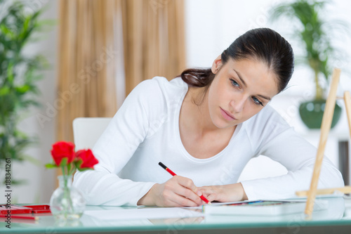 young woman trying to draw the flower