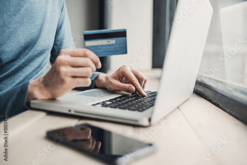 Man holding credit card and using laptop. Online shopping  business and technology concept.