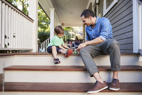 Photography Father And Son Sit On Porch Of House Playing With Toys Together