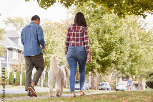 Rear View Of Couple Walking...
