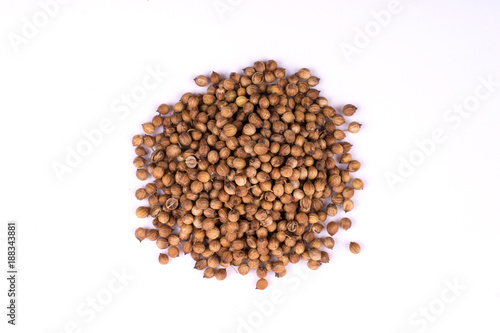 A pile of a dry coriander seeds isolated on white background