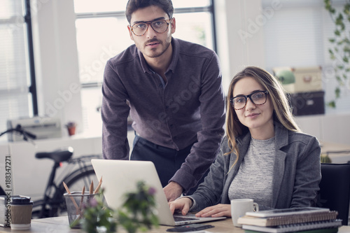 Young colleagues  working on the laptop computer