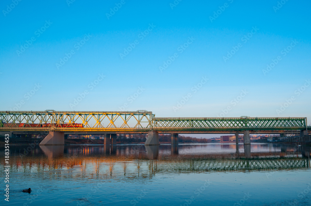 Train and railway bridge in the early cold sunny morning.