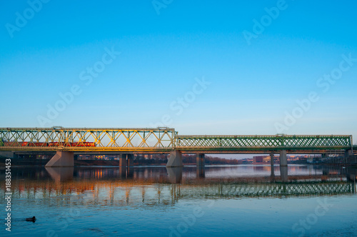 Train and railway bridge in the early cold sunny morning.