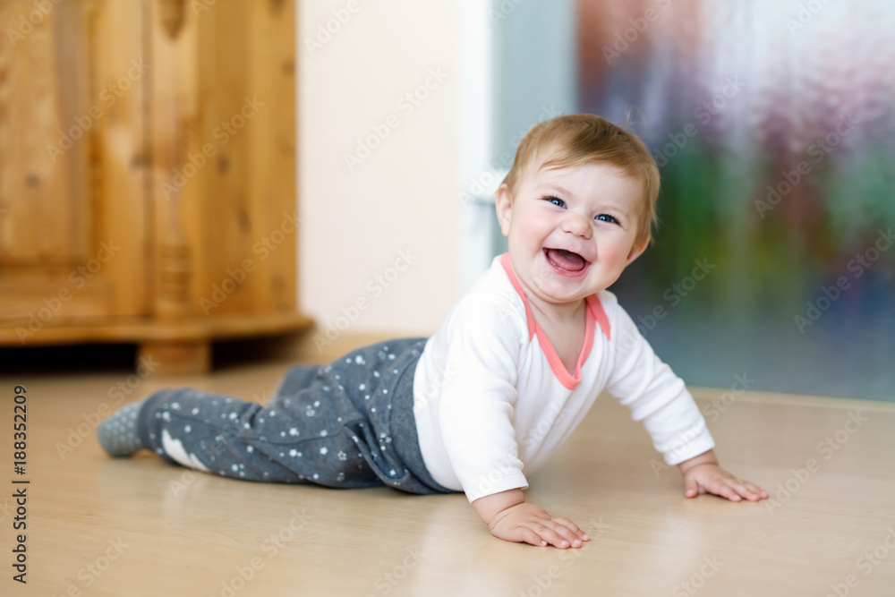 Little smiling happy cute baby girl learning to crawl. Little smiling happy cute baby girl learning to crawl.