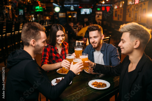 Group of friends having fun in a sport bar